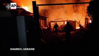 Ukraine firefighters tackle flames in Kharkiv after another Russian strike.