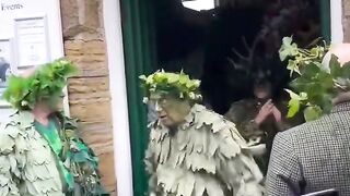 Fenomena unik para warga berpakaian diselimuti daun