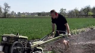 The guy pulls himself up on a tillerblock while working