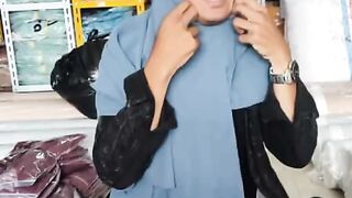 Someone is trying on a veil