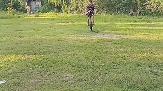 a handsome teenager sports on a bicycle