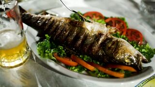 Pouring a sauce on cooked fish