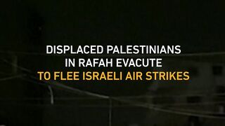 Displaced Palestinians evacuate at night to flee Israeli strikes on Rafah