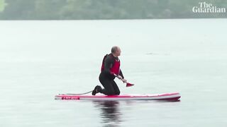 Liberal Democrat leader Ed Davey slips off paddleboard into lake.