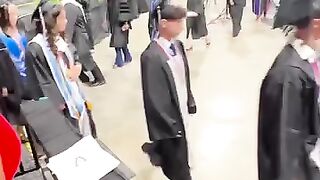 Surprising her sister at her graduation.