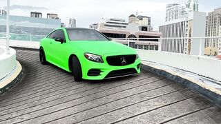 A green Mercedes-Benz driving on a parking ramp