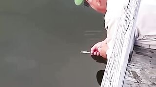 This grandfather catches fish with his bare hands