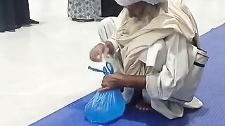One Babaji Haji is trying to pour Zamzam water into the shopper