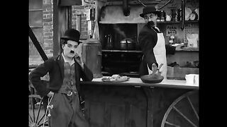 Charlie_Chaplin_and_his_brother_Sydney_in_a_scene_from_A_Dog_s_Life__1918_(360p).