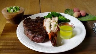 Steak and lobster with vegetables