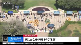 Pro-Palestinian protesters march across UCLA campus carrying fake corpses