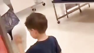 Funny Kid in Garments Shop