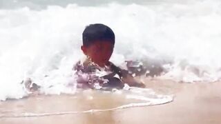 Palestinian boy with amputated limbs plays on Gaza Beach