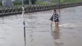 E-Scooter Ride Through Puddle