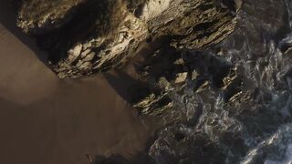 Waves crash on a cliff