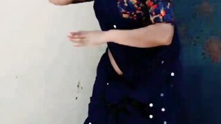 A beautiful lady is dancing on the floor before raining outside.