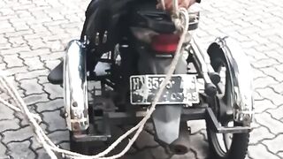 Towing a damaged disabled 3-wheed motorbike