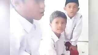 Elementary school children play while reciting the Qur'an.