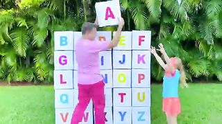 Nastya and dad open boxes with surprises to learn the alphabet.