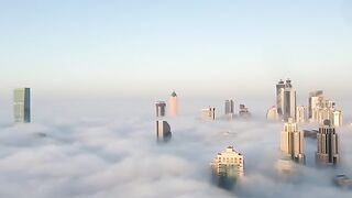 Burj Khalifa and Dubai Downtown are raising from the fog(360p).