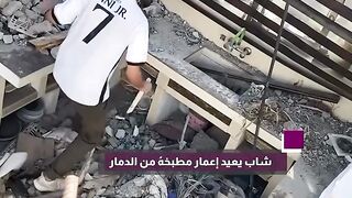 A young man rebuilds a kitchen after the destruction