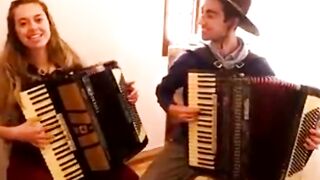 A pair of accordionists playing and singing beautifully.