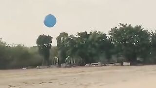 All friends playing with one balloon