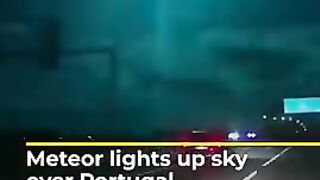 bright blue-green meteor streaking across the night sky over Portugal.