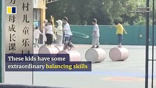 Children practise tricks while walking on cylinder in kindergarten