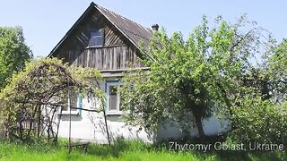 Ukrainian girl cooks Ukrainian Green Borscht in the village, yard work, countryside aesthetics