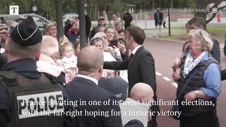 Macron votes in legislative run-off.