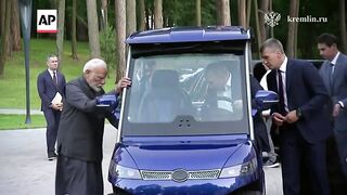 Putin gives Indian PM Narendra Modi a tour of his residence.