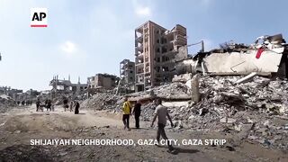 Palestinians return to devastation in Gaza City district after Israeli troops withdraw.