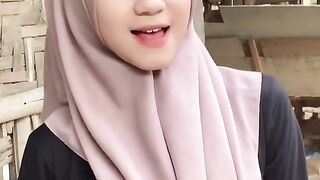 beautiful hijab-wearing woman playing tik tok