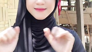 beautiful hijab-wearing woman playing tik tok 2