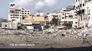 Residents of Gaza City neighborhood return to find homes destroyed by Israeli bombardment.
