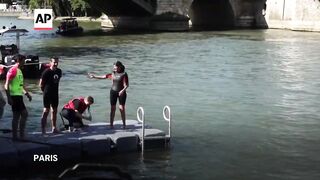 Paris mayor swims in Seine River to showcase its improved cleanliness before Olympics.