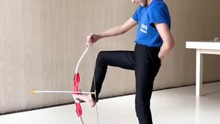 A child using his foot for archery or playing soccer.