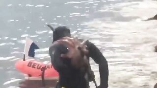 An octopus sticks to a diver's back