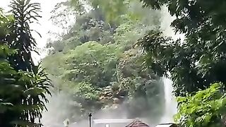 The waterfall on the side of the highway that falls from the hills looks very beautiful.