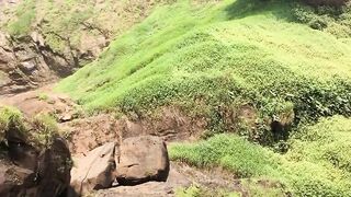 Bathing in a very beautiful, natural and refreshing waterfall.