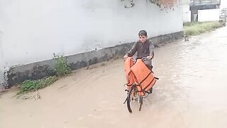 Mujtatba walks through flood