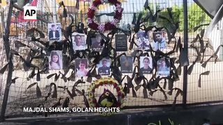 Community in Israeli-controlled Golan Heights holds funerals for people killed in rocket attack.