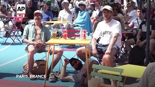 Olympics fans battle the heat outside venues across Paris.