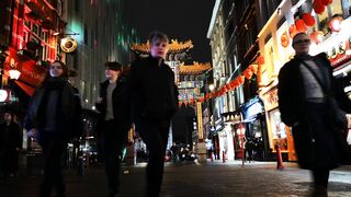 People Passing In And Out Of A China Town Gateway In London