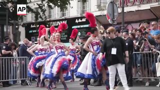 Moulin Rouge dancers perform for cyclists in the Olympics road race.