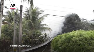 Witnesses react after plane crashes with 61 people aboard in Brazil's Sao Paulo state.