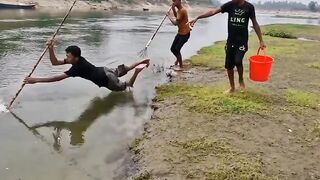 catching fish in the river using wood