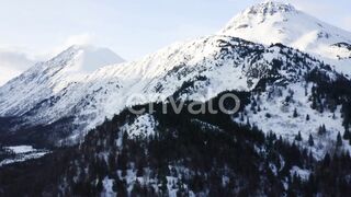 "Aerial View of Snow Covered Mountain Peak – Breathtaking Snowy Panorama!"