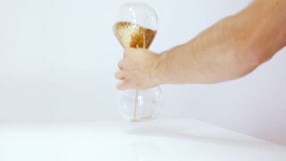 Person Turning Hourglass